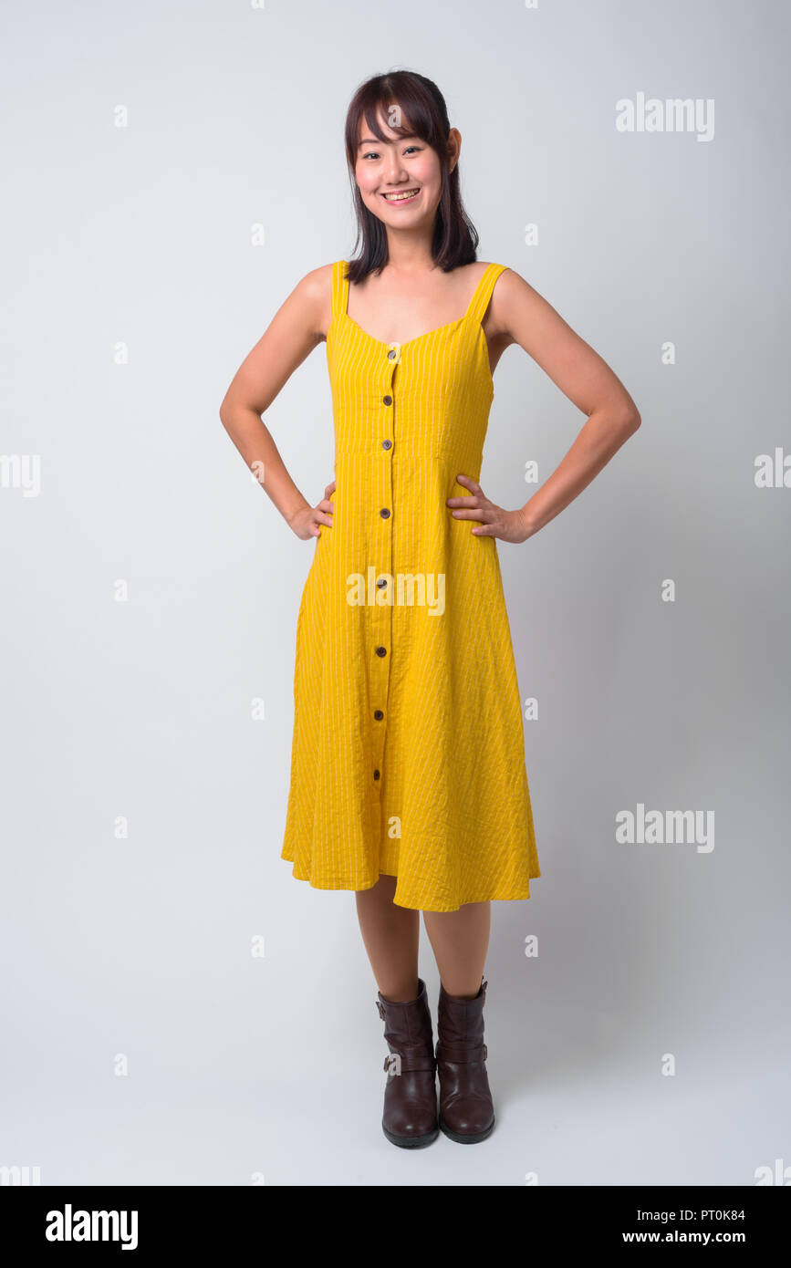 Portrait of beautiful Asian woman wearing yellow dress Stock Photo - Alamy