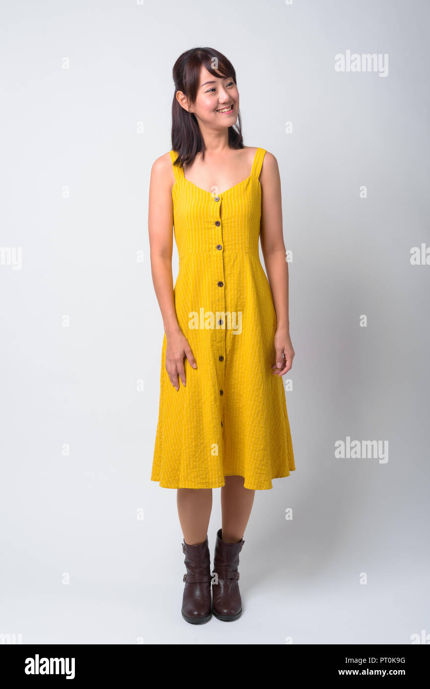 Portrait of beautiful Asian woman wearing yellow dress Stock Photo - Alamy