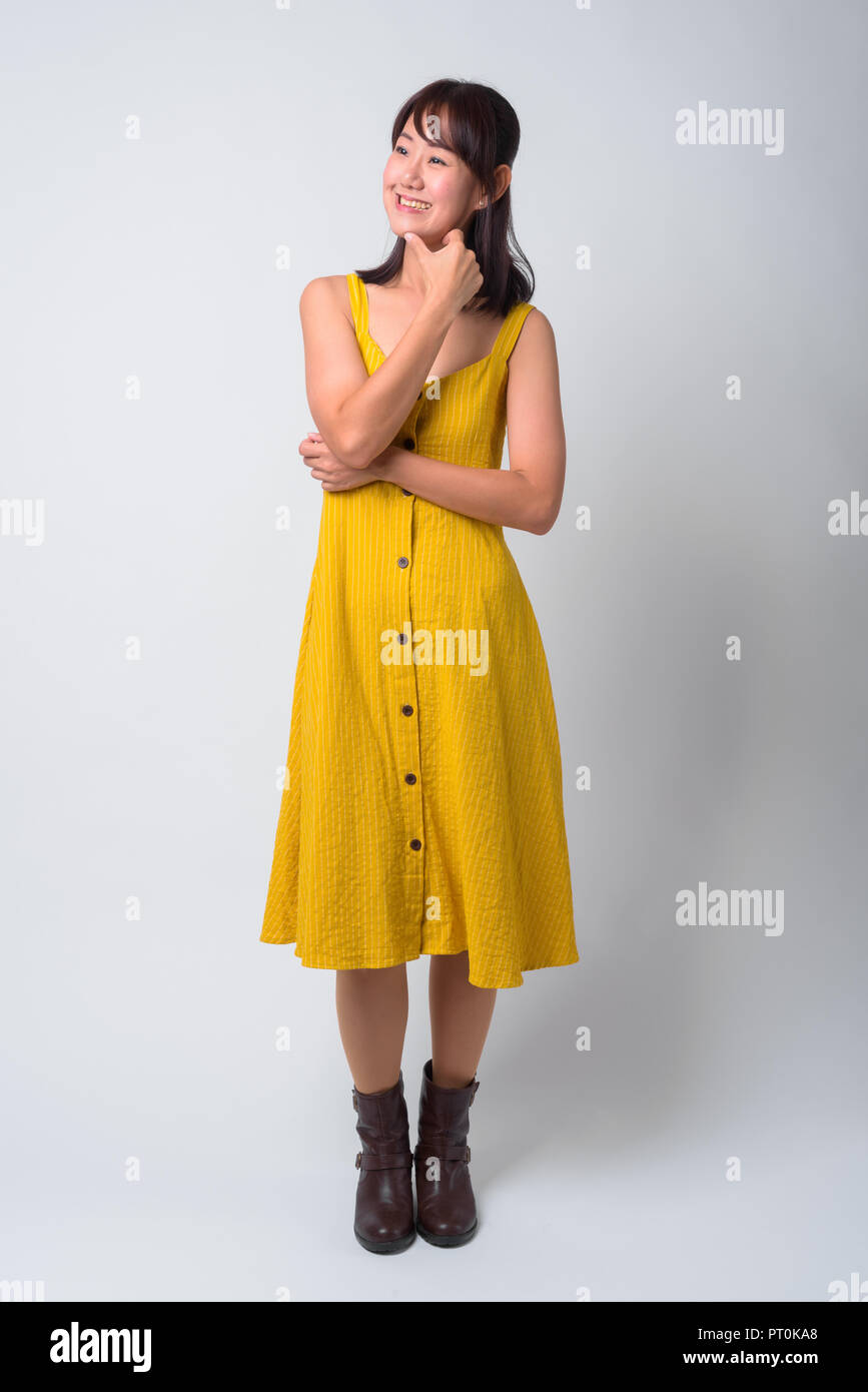 Portrait of beautiful Asian woman wearing yellow dress Stock Photo - Alamy