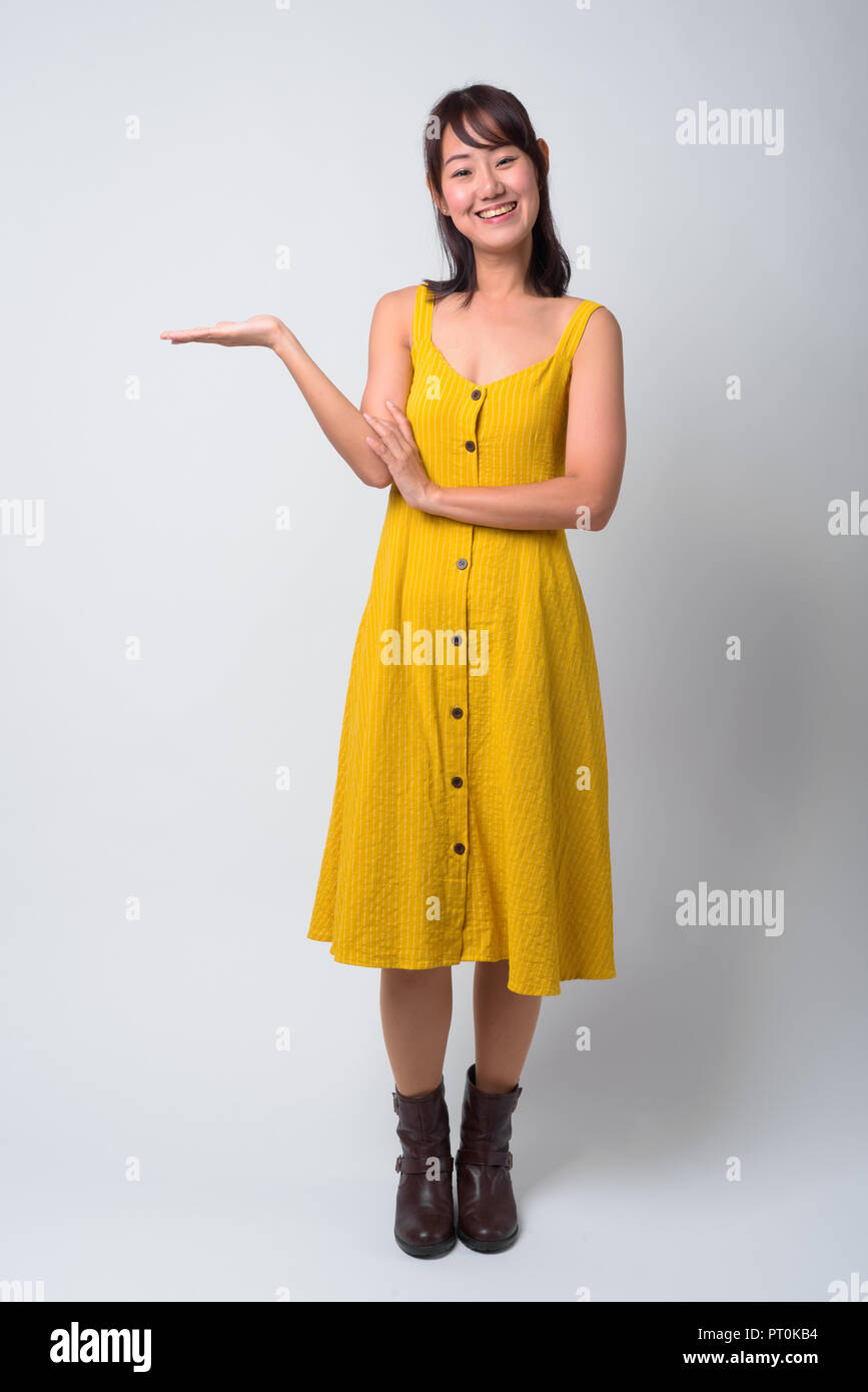 Portrait of beautiful Asian woman wearing yellow dress Stock Photo - Alamy