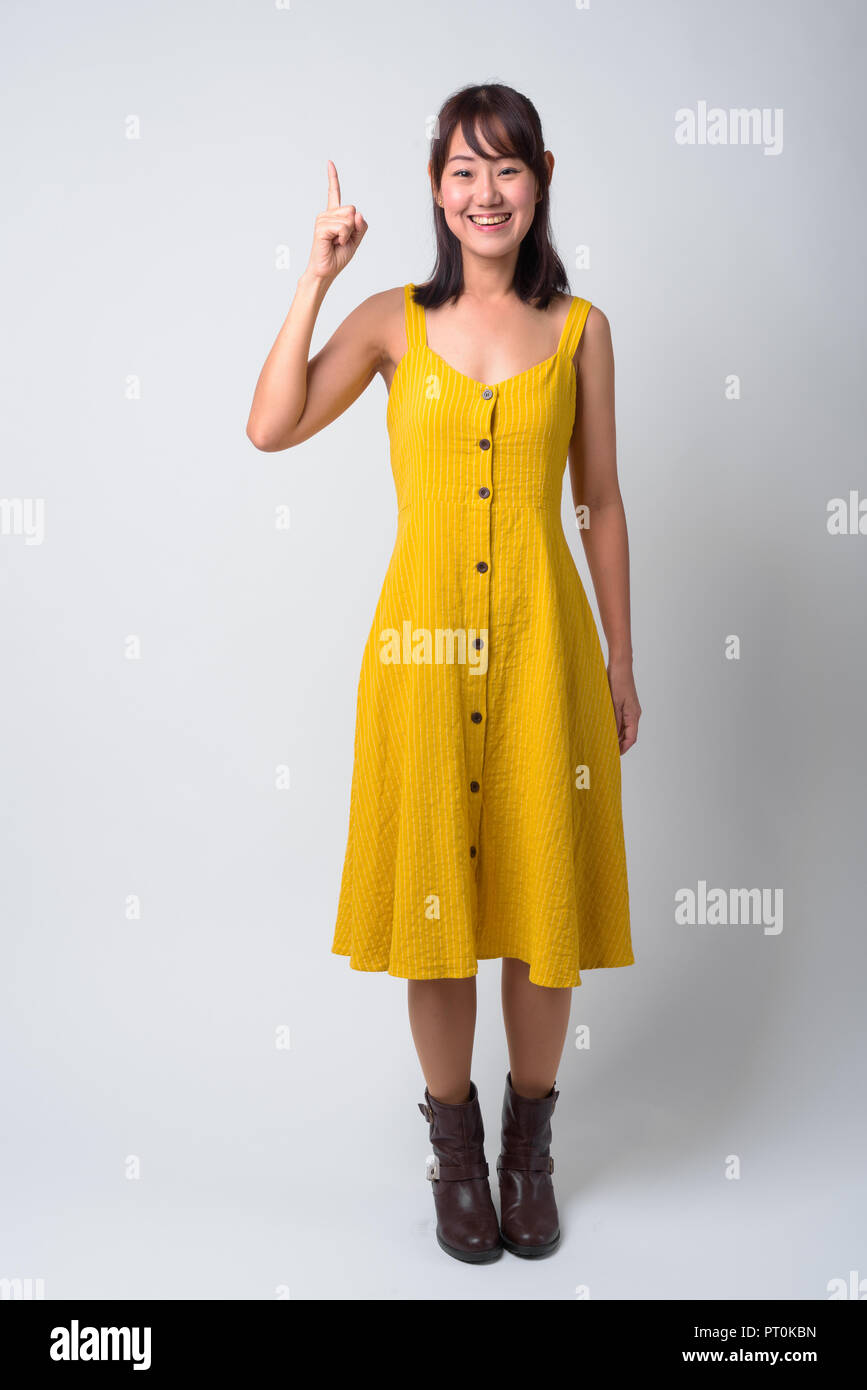Portrait of beautiful Asian woman wearing yellow dress Stock Photo - Alamy