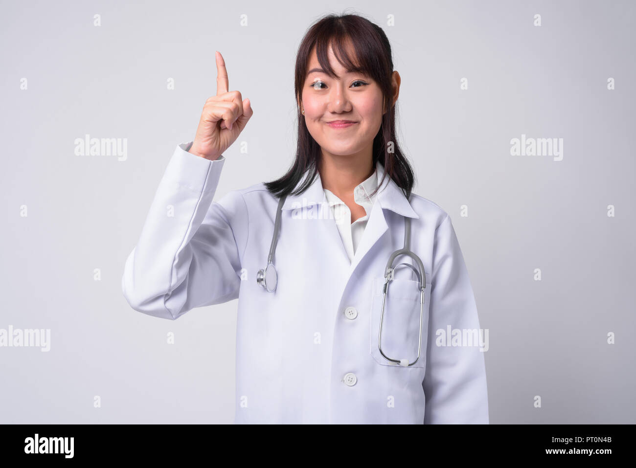 Portrait of beautiful Asian woman doctor against white background Stock ...