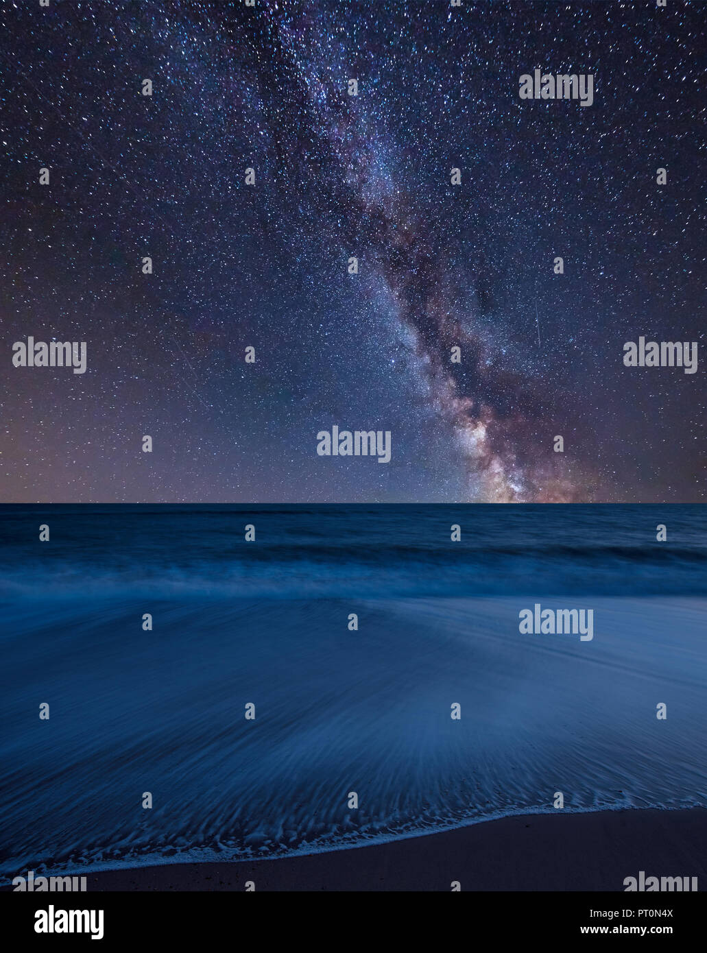 Stunning vibrant Milky Way composite image over landscape of beach long ...