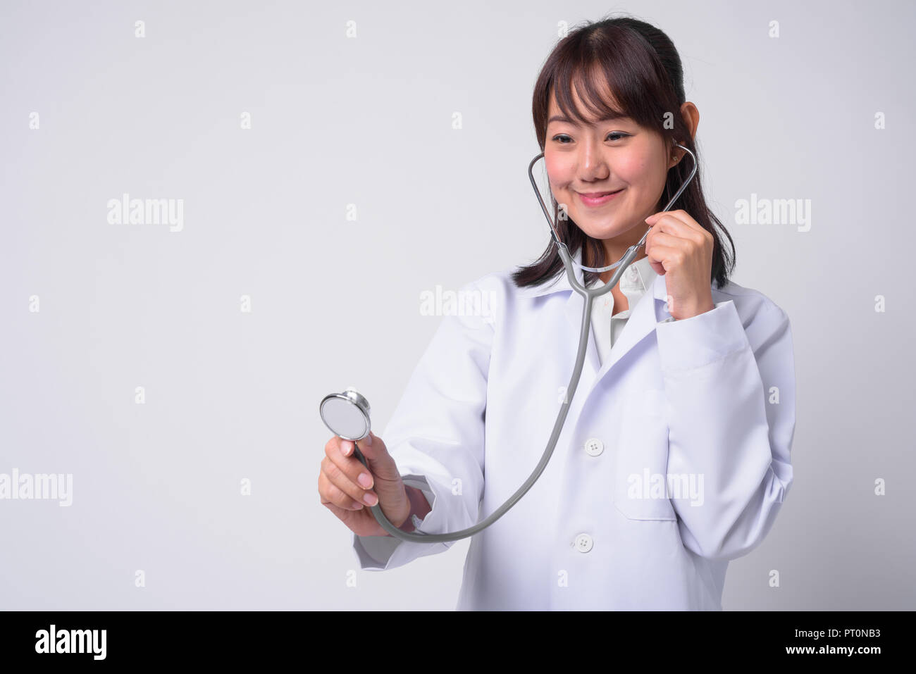Portrait of beautiful Asian woman doctor against white background Stock ...
