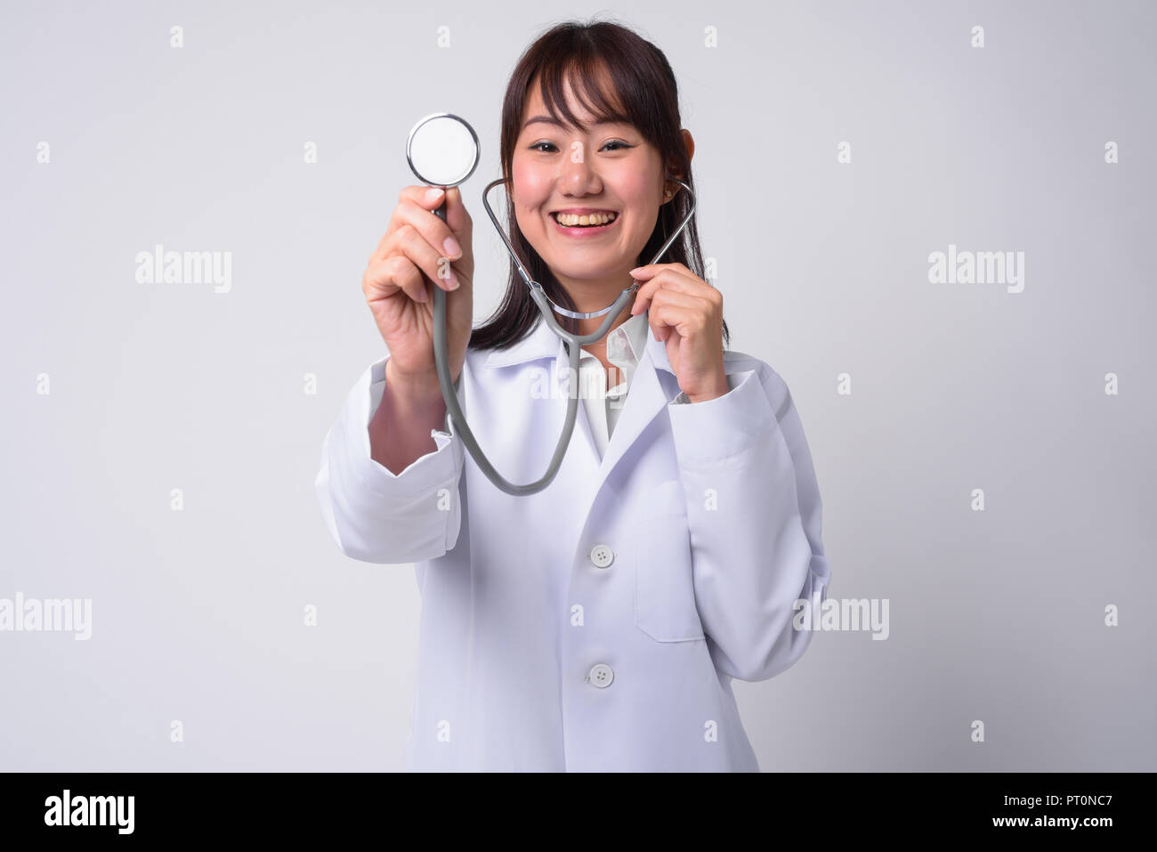 Portrait of beautiful Asian woman doctor against white background Stock ...