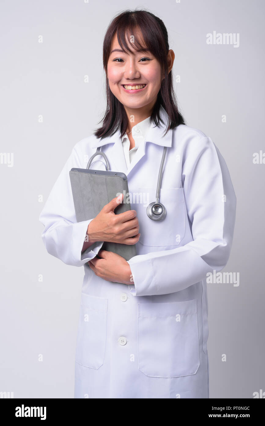 Portrait of beautiful Asian woman doctor against white background Stock ...