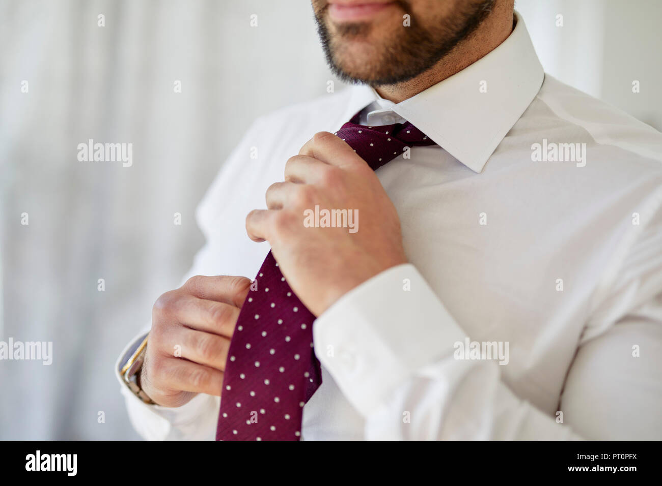 Man adjusting his tie Stock Photo