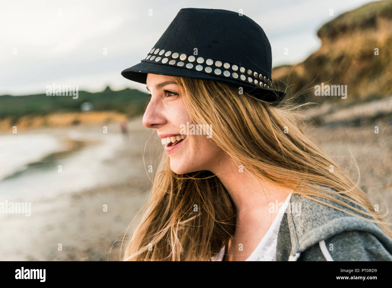 Happy young woman on the beach Stock Photo - Alamy