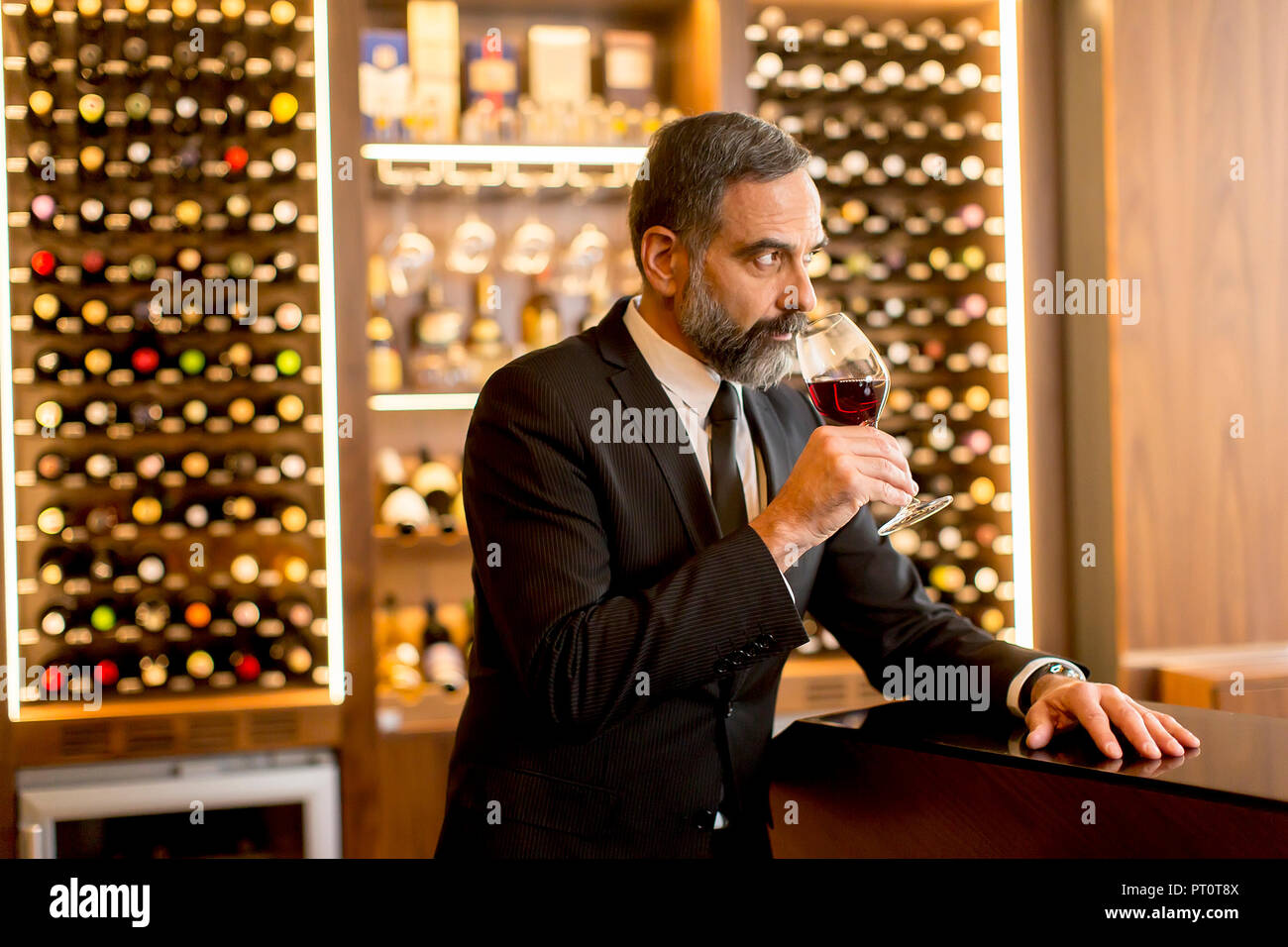 Portrait of senior handsome man drinking red wine Stock Photo - Alamy