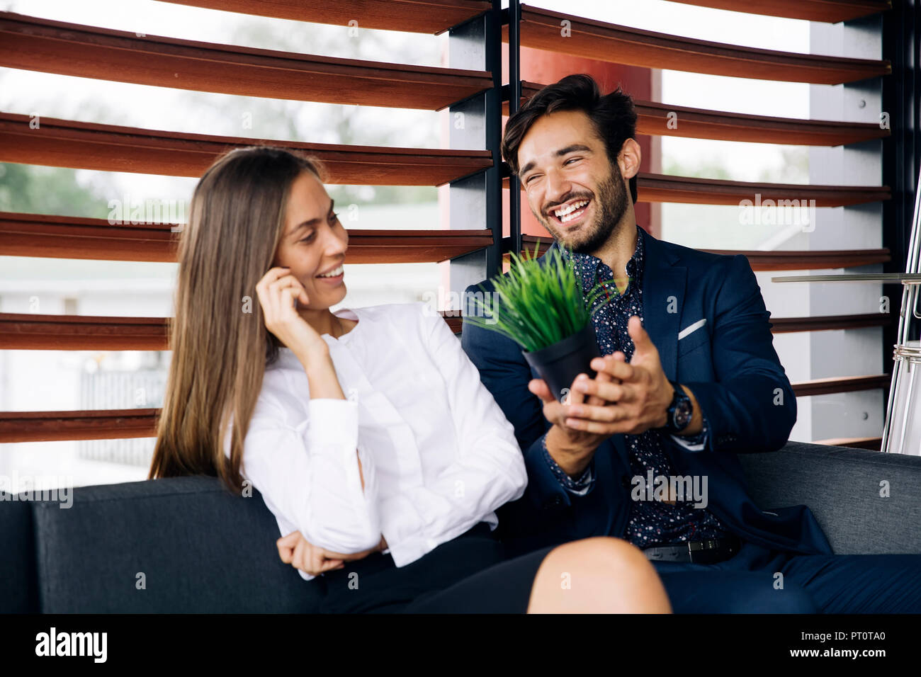 Portrait of young business people while standing in the office Stock ...