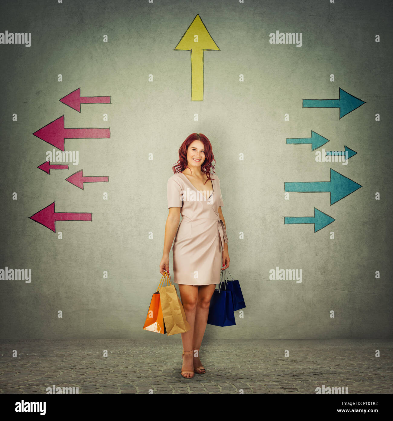 Full length portrait of cute girl carrying paper bags and thinking