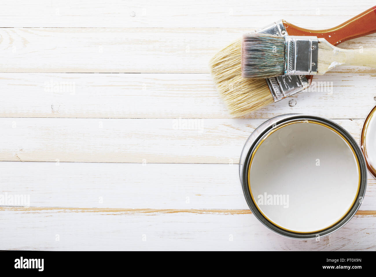 Old used small paint brushes on brushed metal texture background