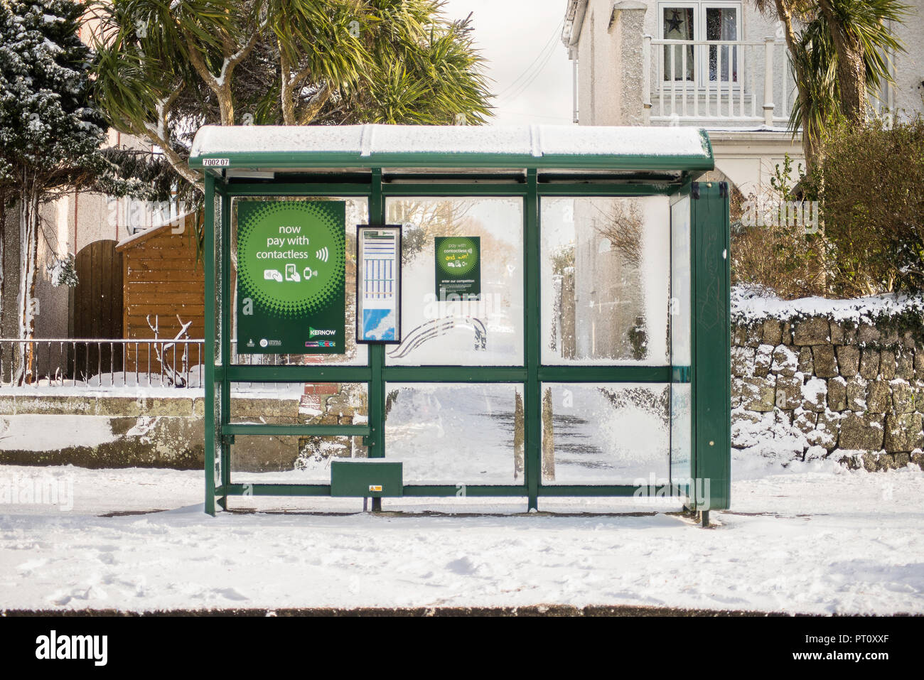Empty bus stop on a snowing day in Falmouth town, Cornwall Stock Photo