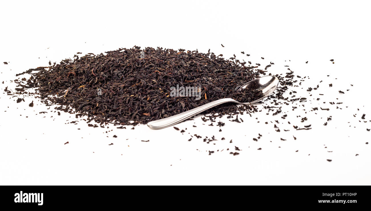 Dry black tea leaves with teaspoon isolated on white Stock Photo Alamy