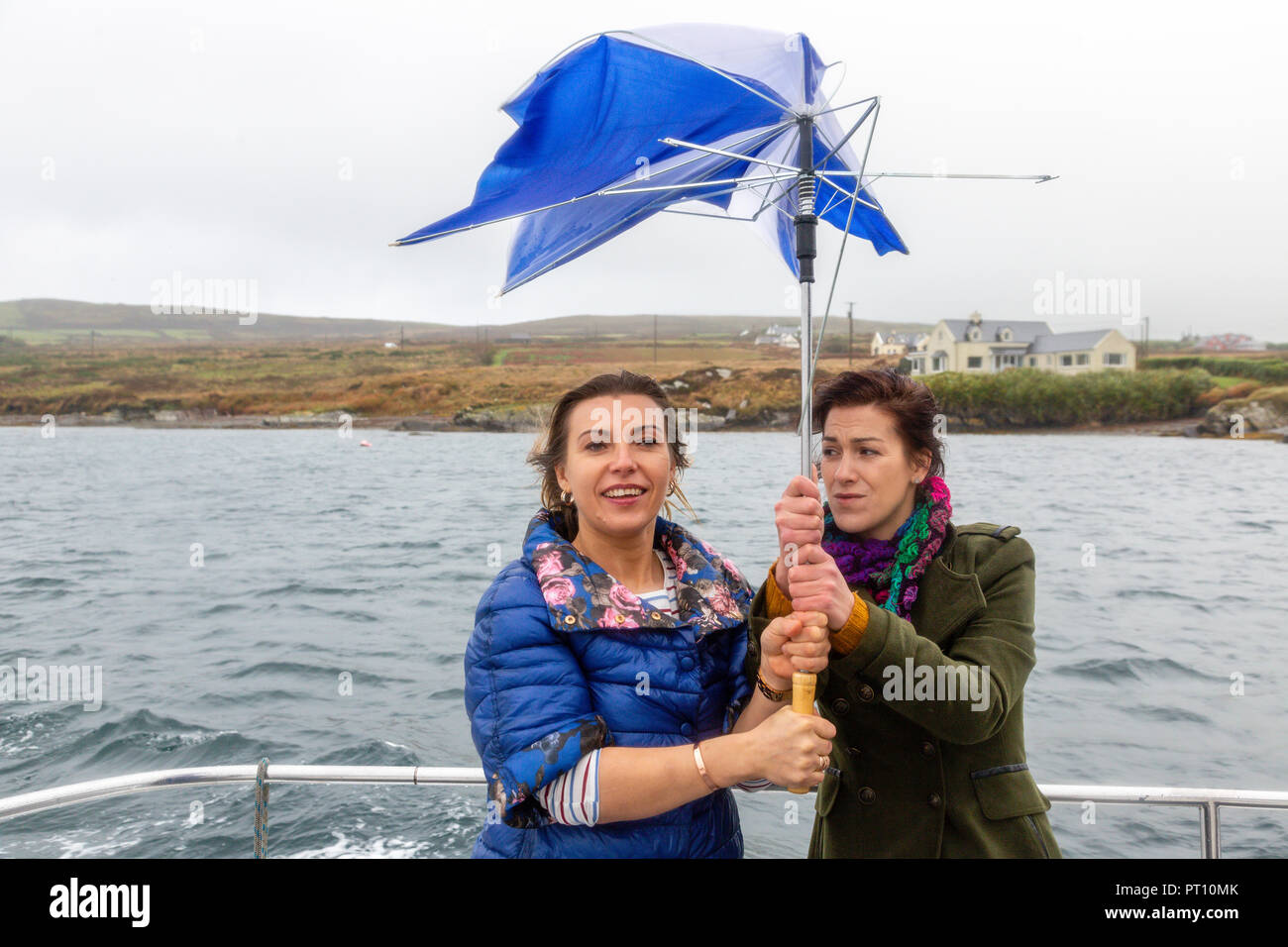 Two women with broken umbrella, Ireland Stock Photo