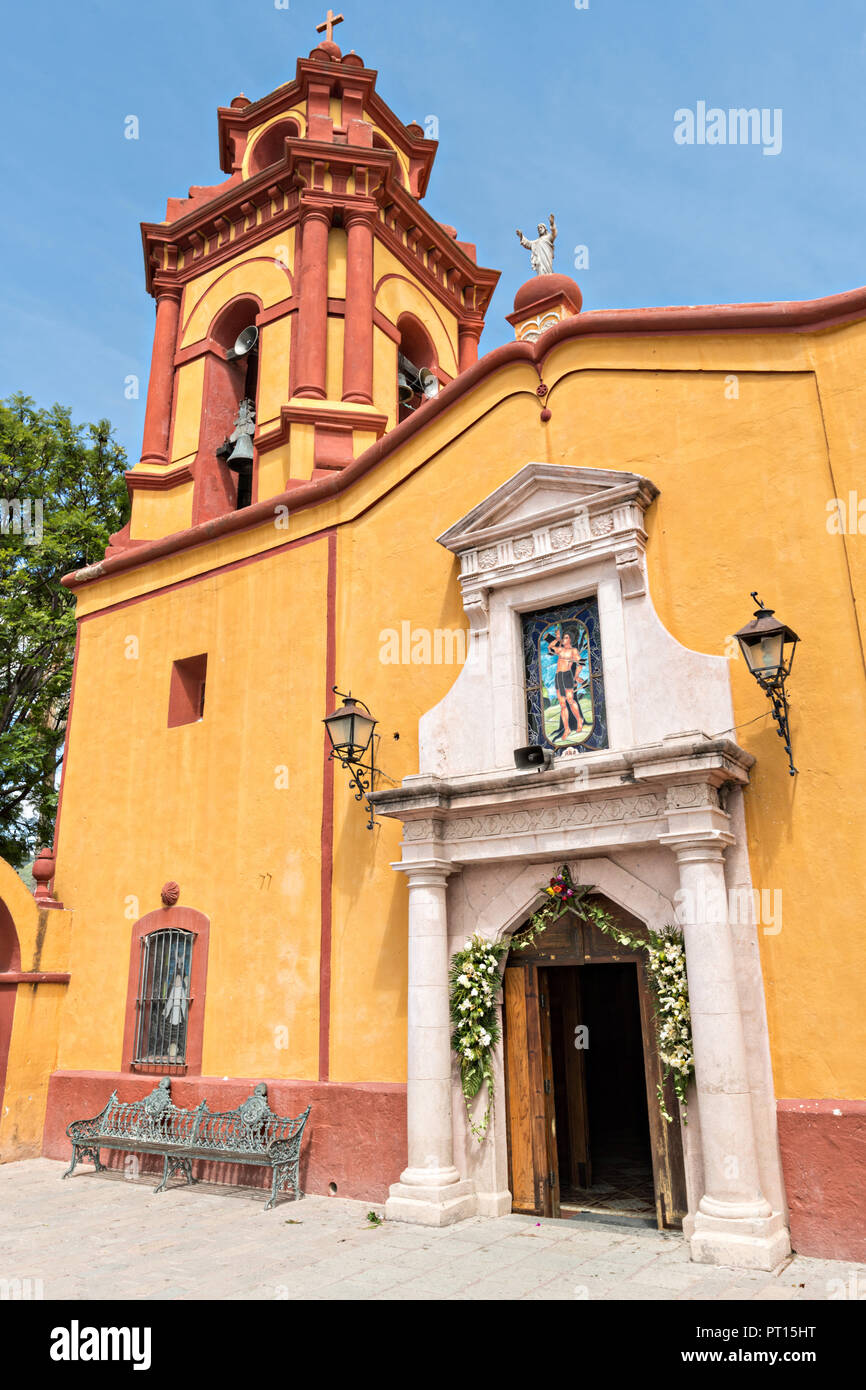 The Parroquia San Sebastian church in the beautiful colonial village of Bernal, Queretaro, Mexico. Bernal is a quaint colonial town known for the Pena de Bernal, a giant monolith which dominates the tiny village is the third highest on the planet. Stock Photo