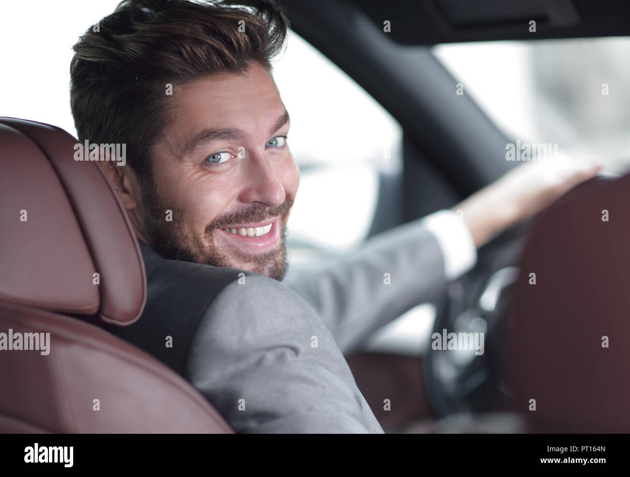 Portrait of an handsome smiling business man driving his car Stock ...
