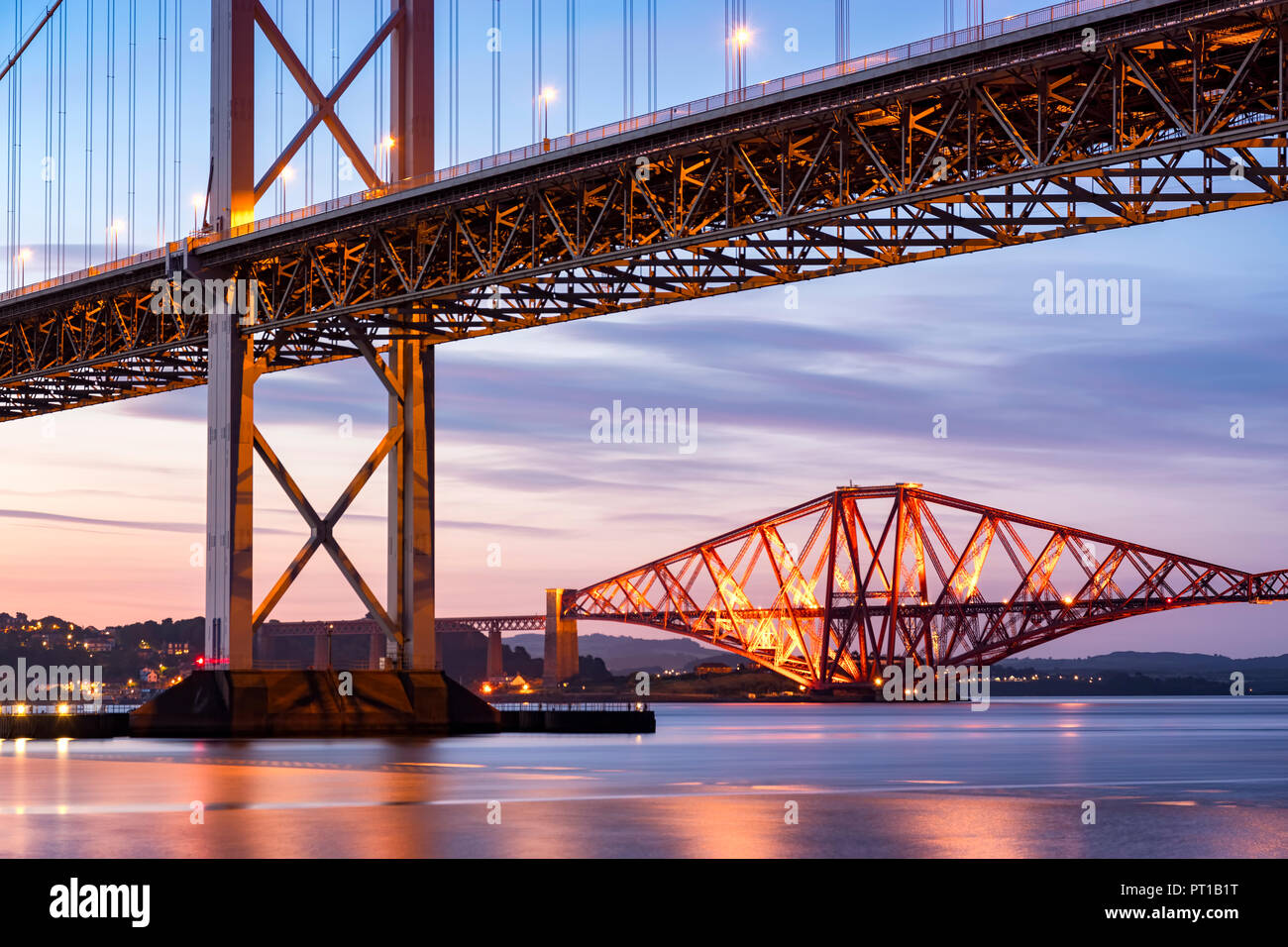 UK, Scotland, Fife, Edinburgh, Firth of Forth estuary, Forth Bridge (Rail) and Forth Road Bridge at sunset Stock Photo