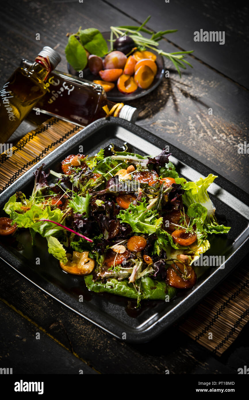 Leaf lettuce with steamed plums, champignons, almonds and cress Stock Photo