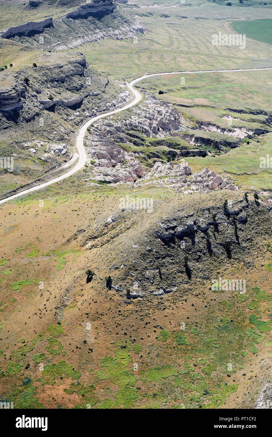 USA, Aerial of escarpments and cliffs bisected by a country road in Western Nebraska Stock Photo
