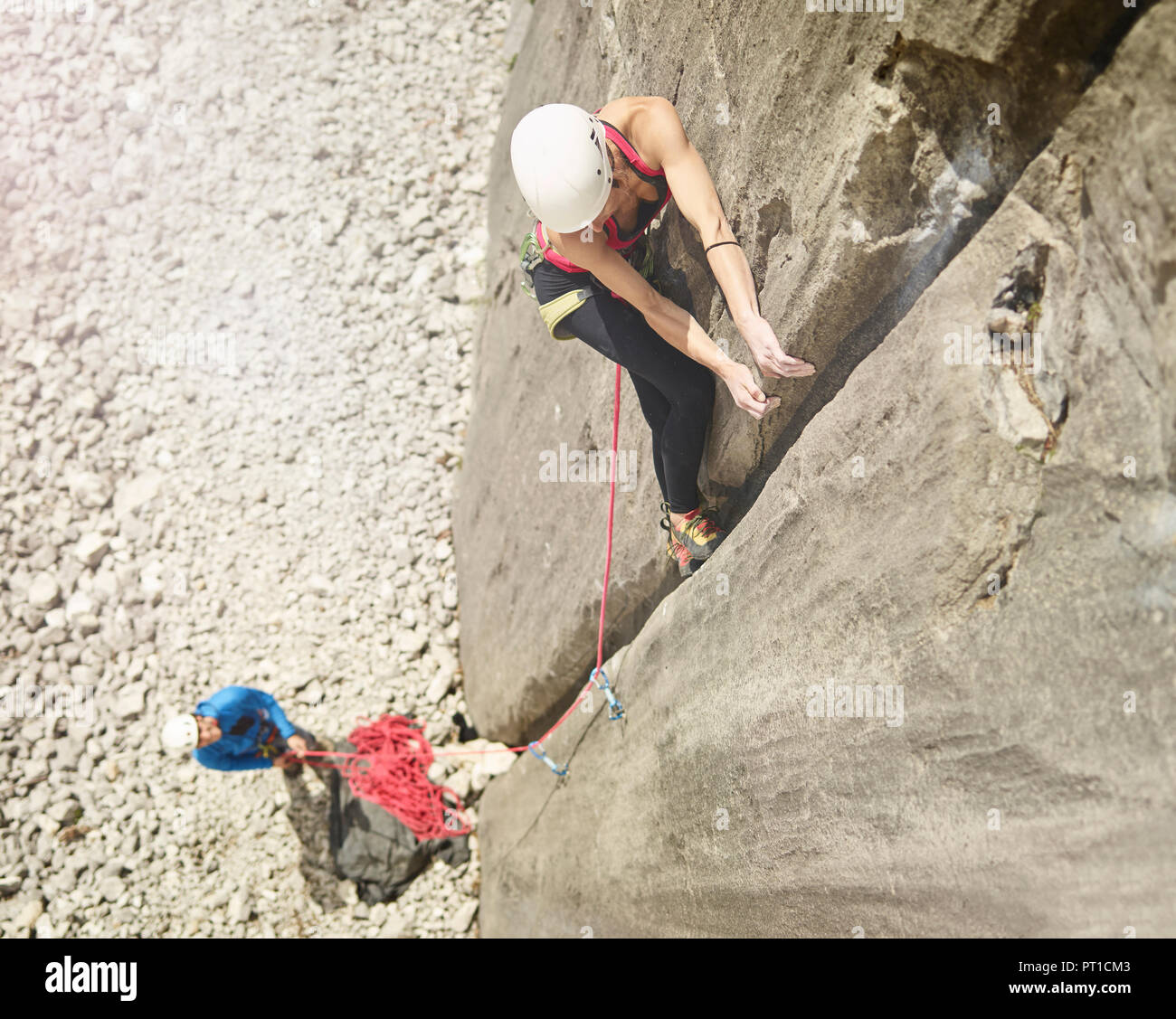 Austria, Innsbruck, Martinswand, woman climbing in rock wall Stock Photo