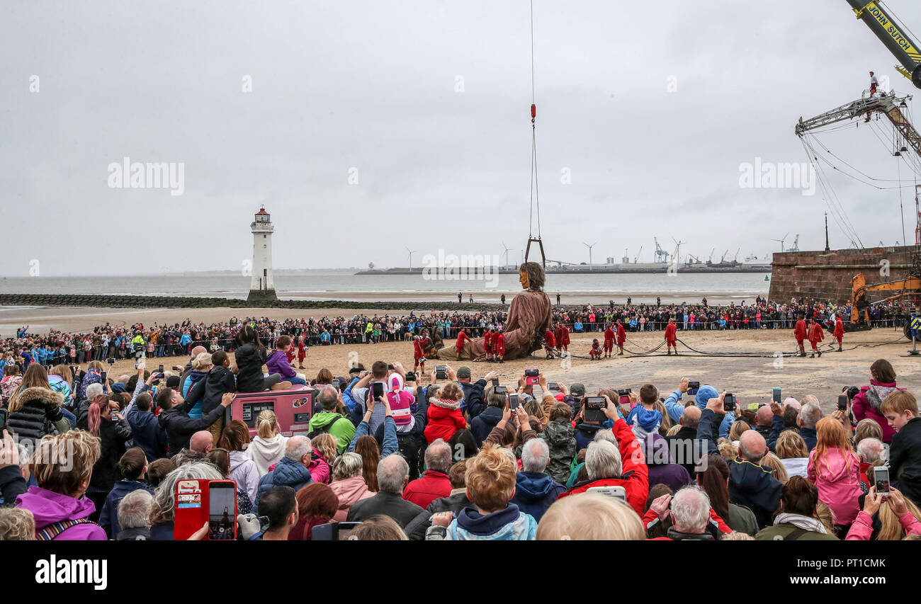 The Giant Man on the beach at New Brighton, Wirral, 'rises after he is woken following being shipwrecked', as part of the Royal De Luxe Giant Spectacular over the weekend. Stock Photo