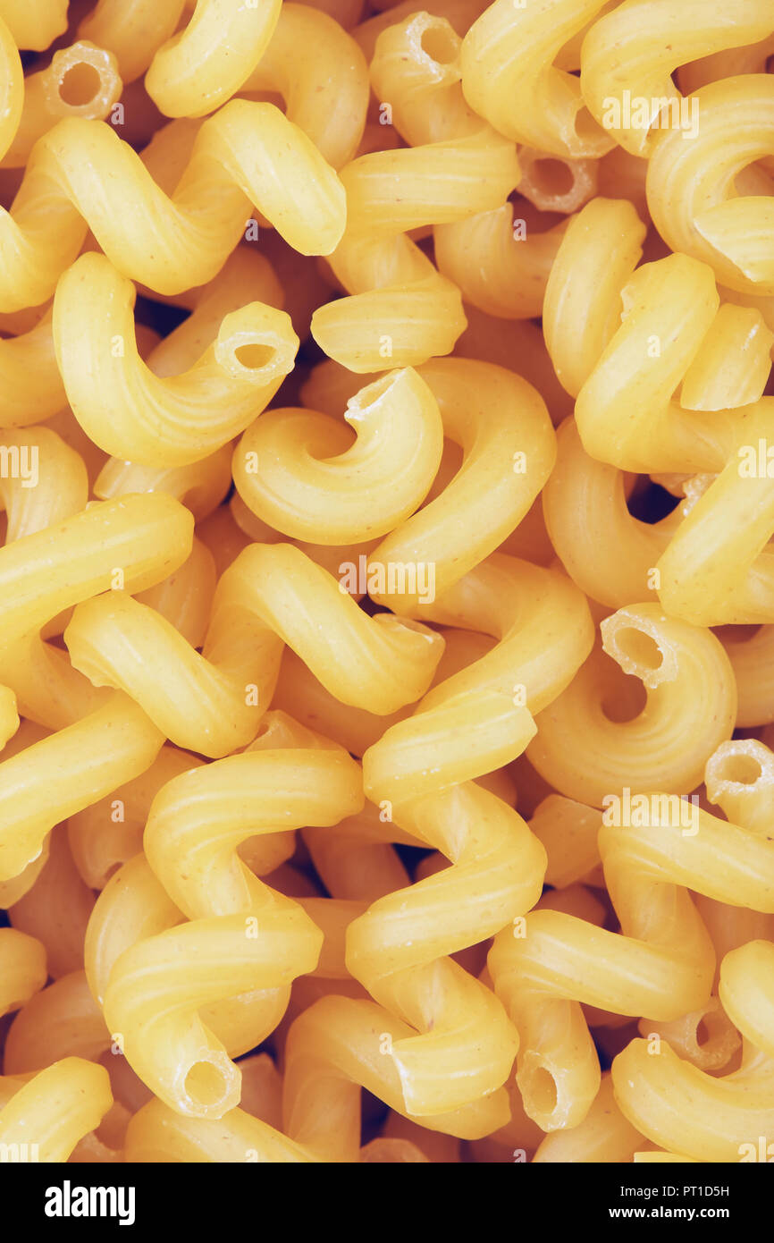 colorful raw spiral pipe pasta background, close up Stock Photo