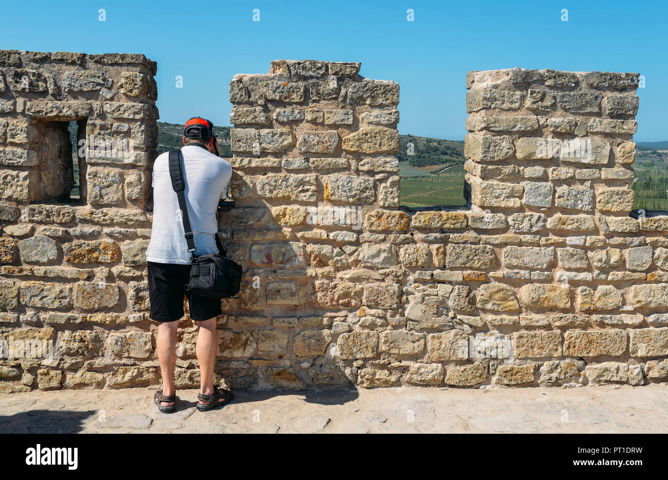 Lone unidentifiable tourist at castle Ramparts at Castelo de Obidos, Obidos, Leiria District, Pinhal Litoral, Portugal Stock Photo