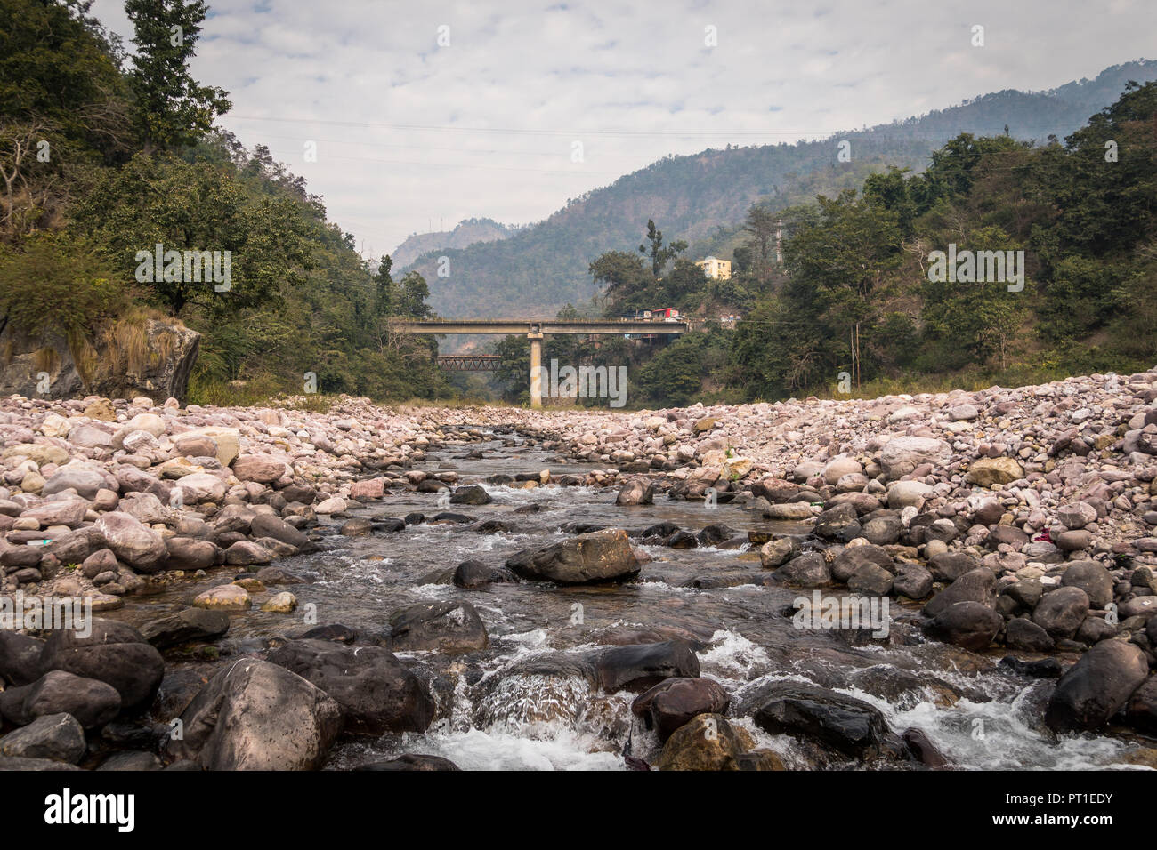 A beautiful landscape in the mountains with a bridge over the Ganges River near the city of Rishikesh India Stock Photo