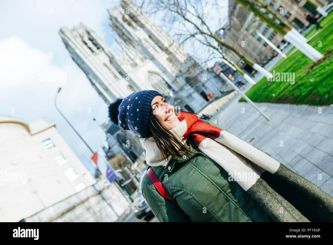 Belgium, Brussels, woman with winter clothes in front of Brussels Cathedral Stock Photo