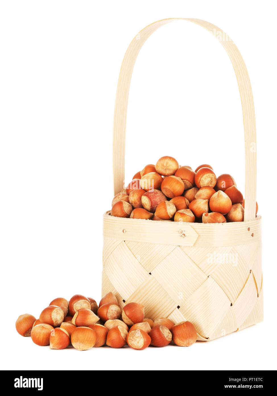 hazelnuts in wooden basket, isolated on white background Stock Photo