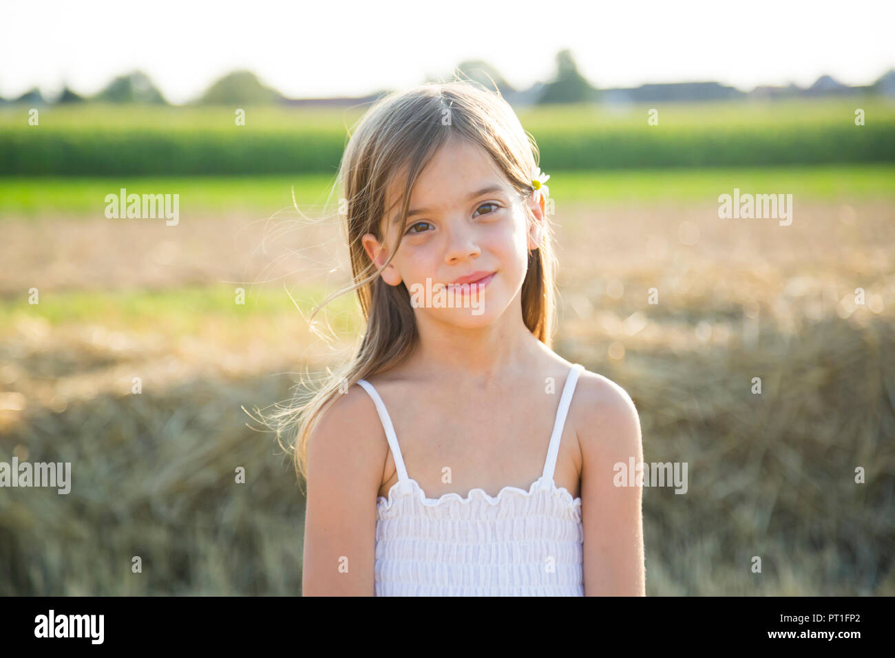 Portrait of smiling little girl in nature Stock Photo - Alamy