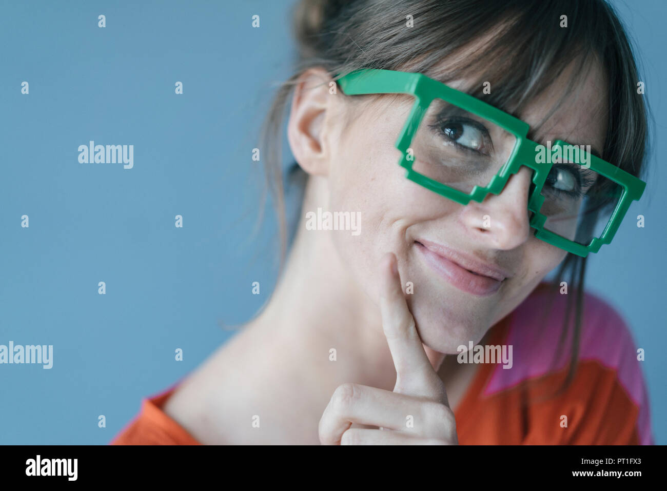 Young woman wearing pixel glasses, smiling Stock Photo