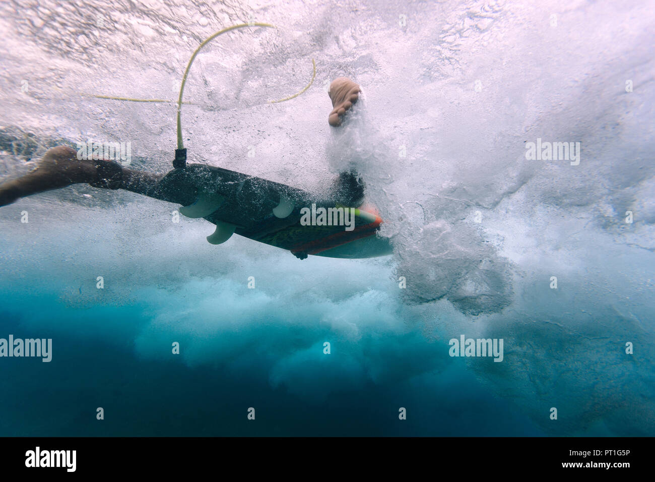 Maledives, Indian Ocean, surfer on surfboard, underwater shot Stock Photo