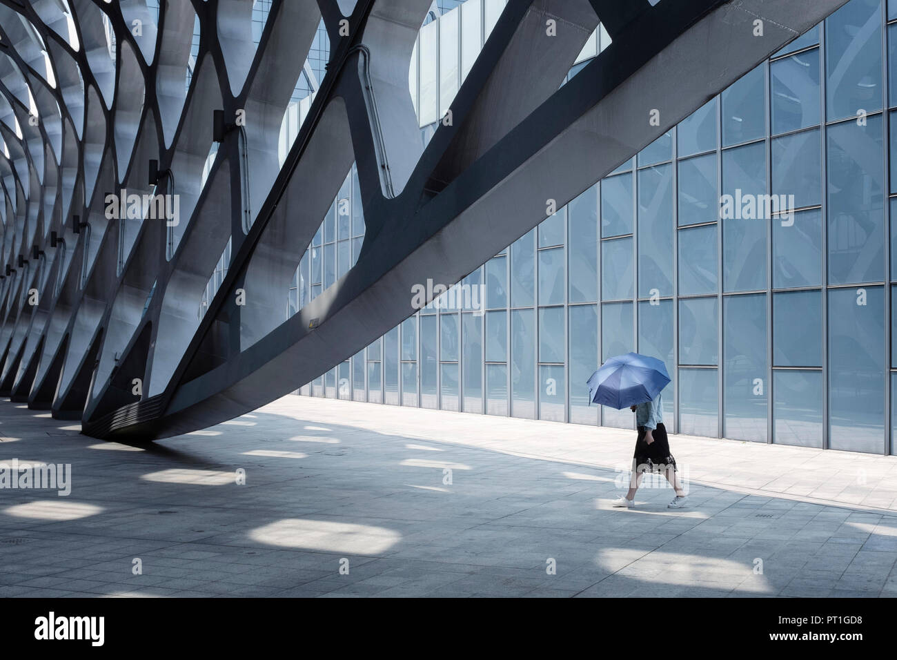 China, Shenzhen, modern architecture and walking woman Stock Photo
