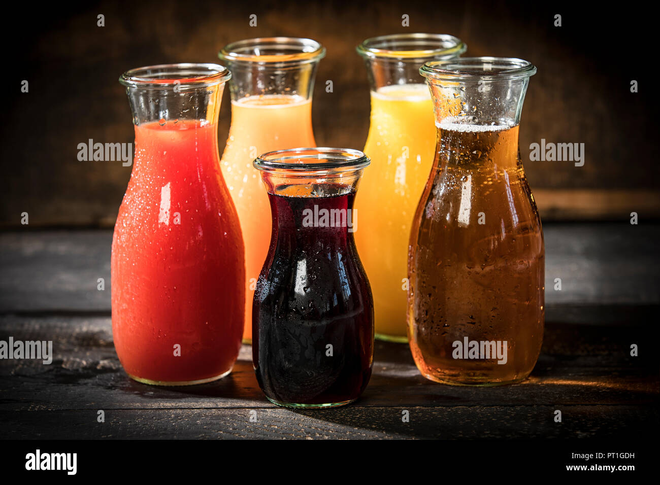 Glass bottles of various fruit juices Stock Photo