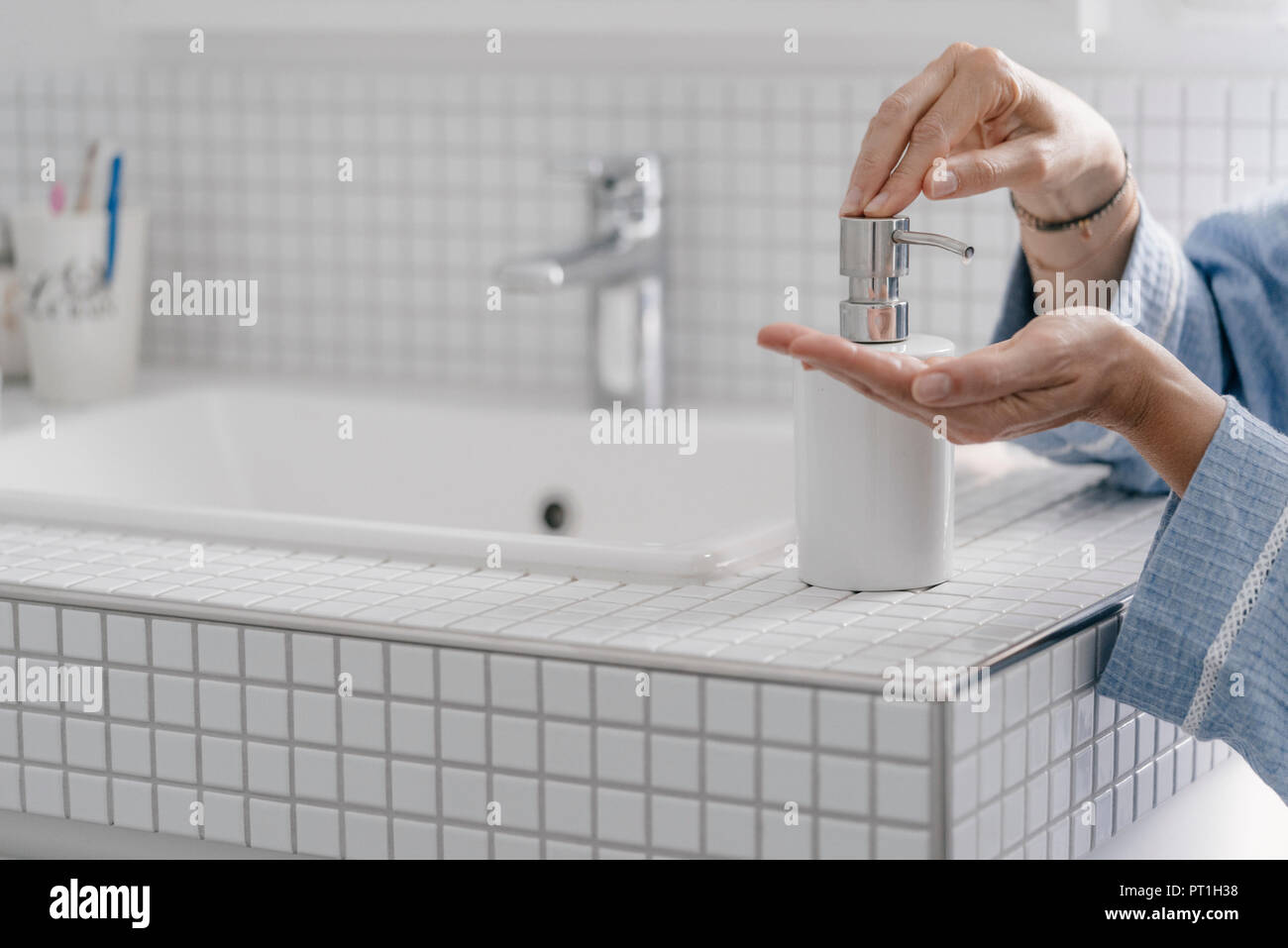 Close-up of woman wputting soap on her hands in bathroom Stock Photo