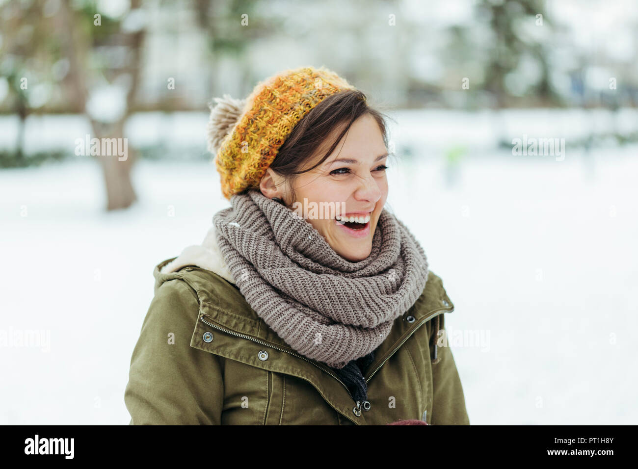 Portrait of laughing woman in the snow Stock Photo - Alamy