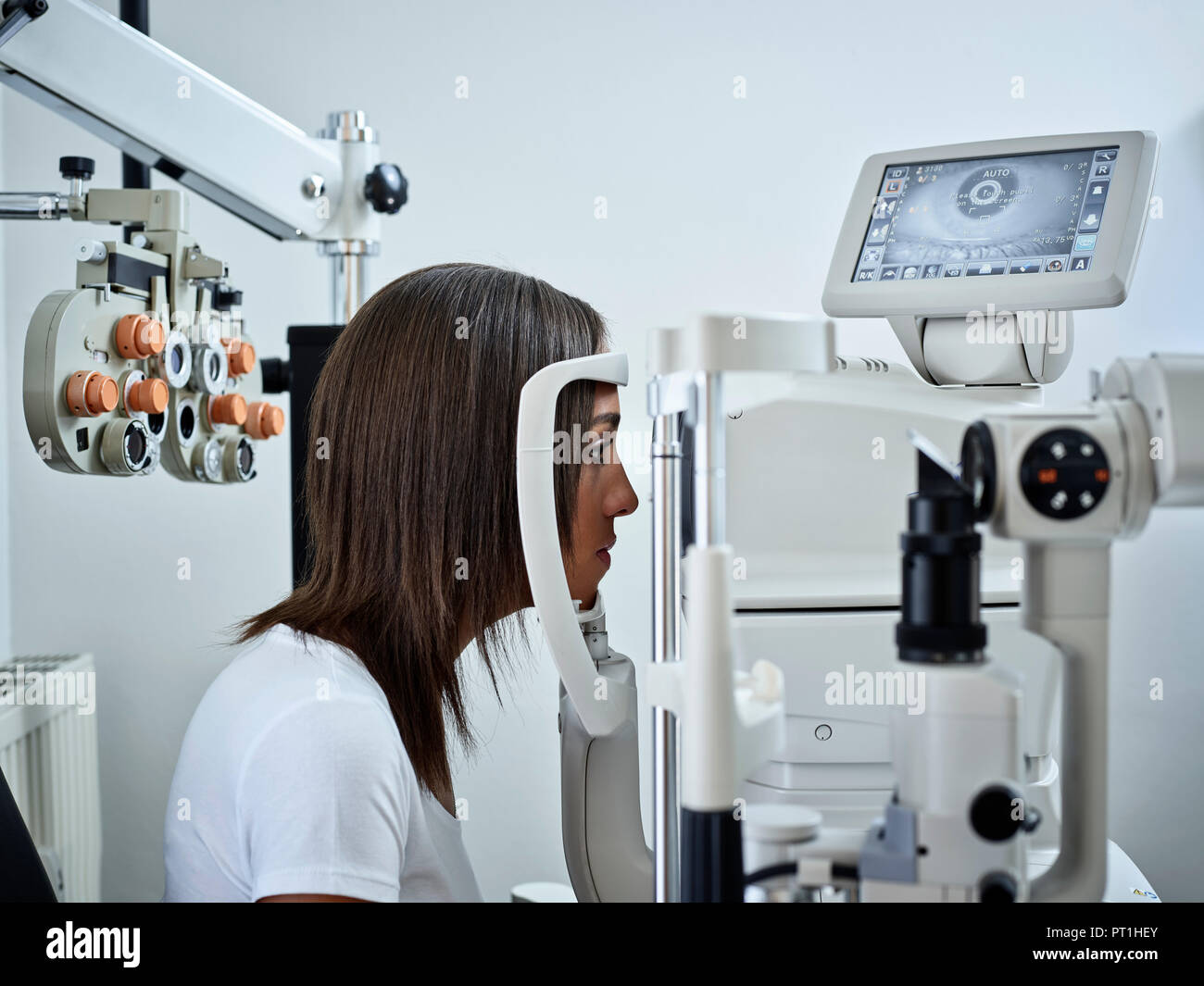 Optician, Young woman during eye test Stock Photo