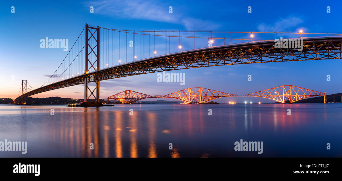 UK, Scotland, Fife, Edinburgh, Firth of Forth estuary, Forth Bridge (Rail (Orange)) and Forth Road Bridge at sunset Stock Photo