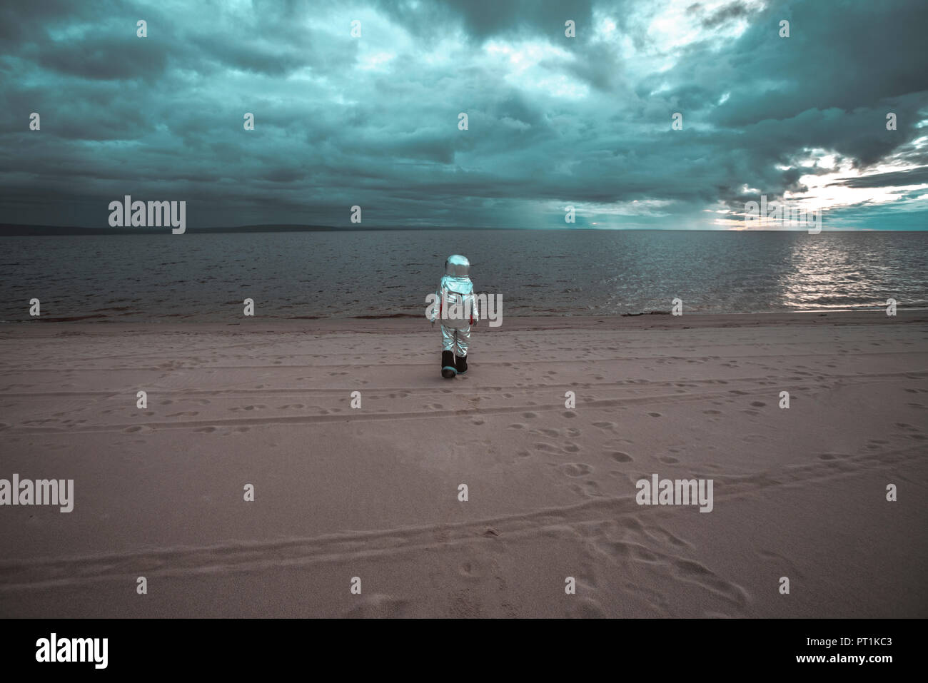 Lonely spaceman looking at lake on nameless planet Stock Photo