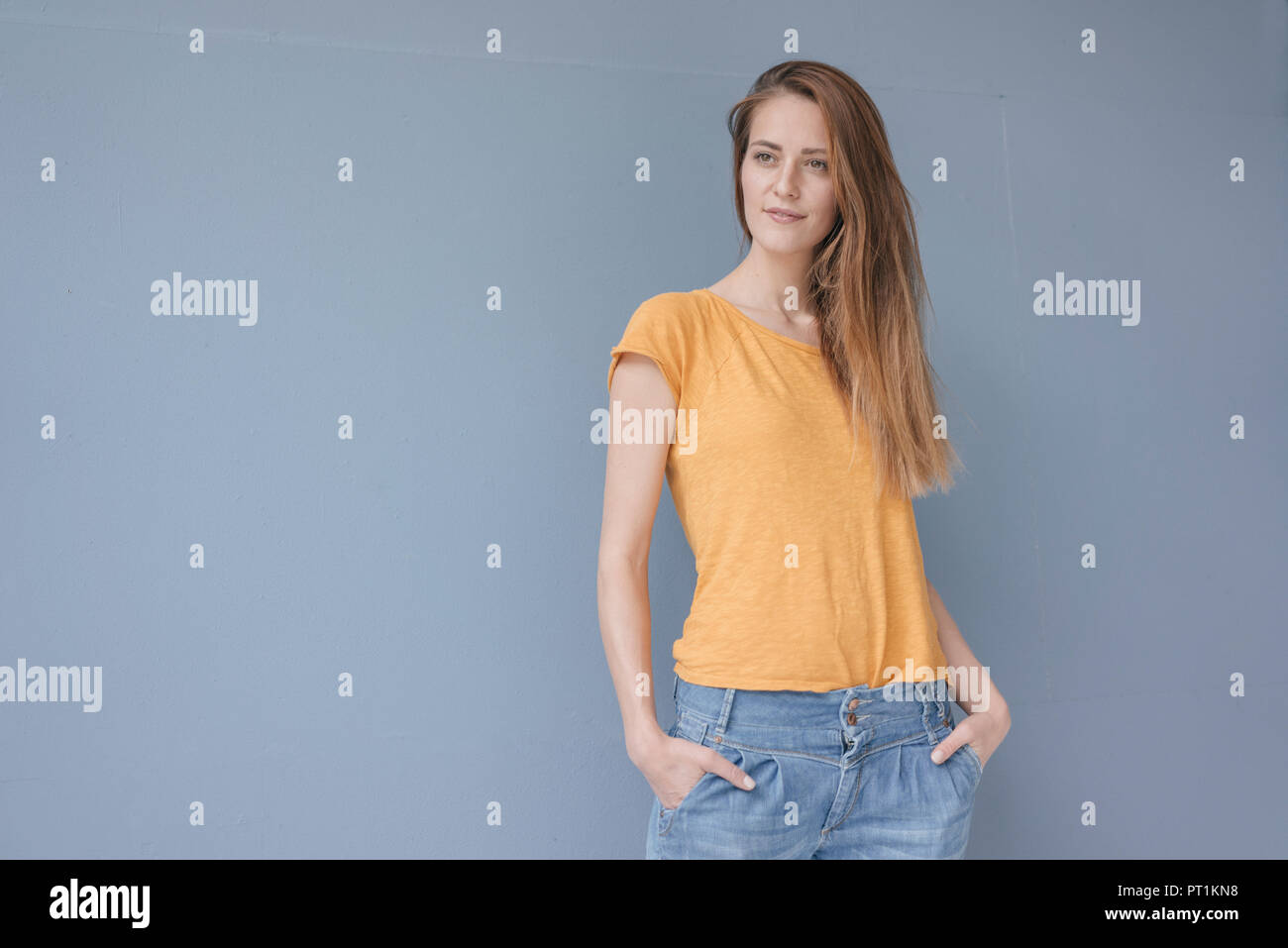Portrait of a pretty woman with hands in pockets Stock Photo