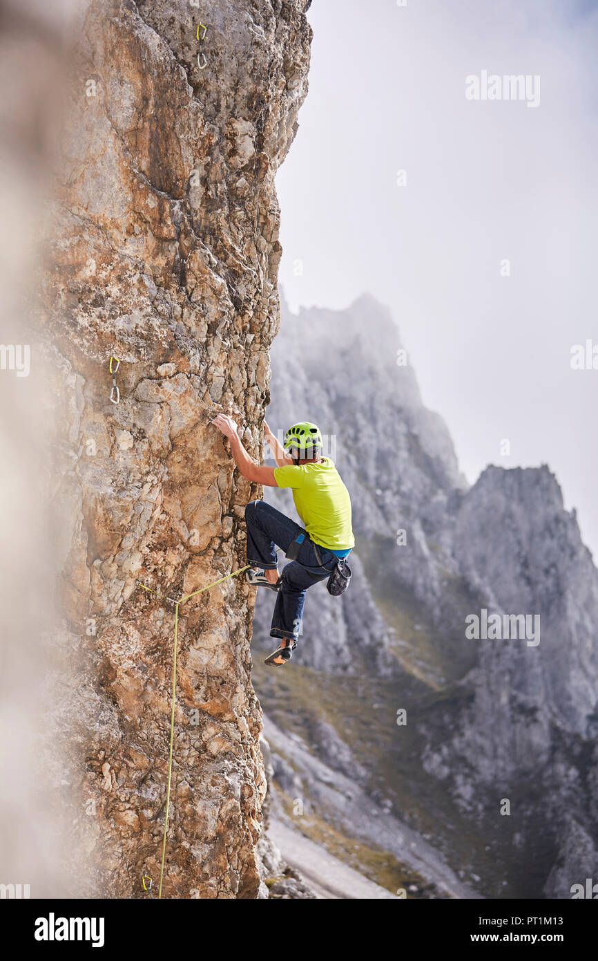 Austria, Innsbruck, Nordkette, man climbing in rock wall Stock Photo