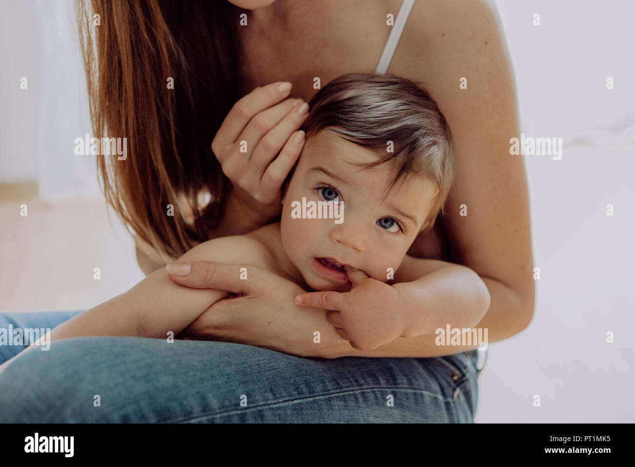 Mother cuddling and playing with her baby son Stock Photo