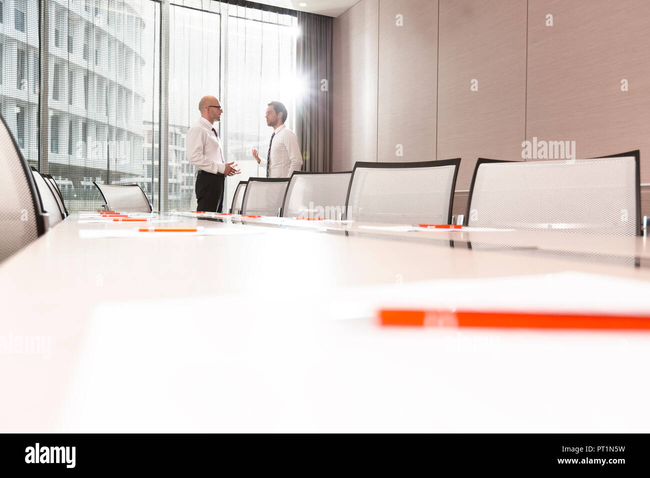 Poland, Warzawa, two businessmen talking at conference room in hotel Stock Photo