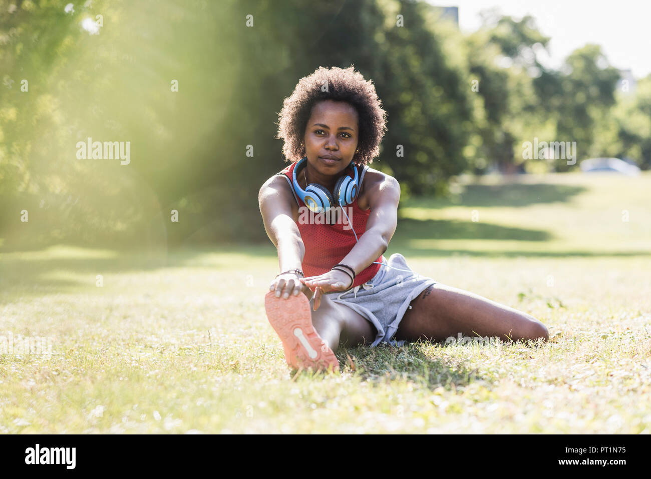 Athlete stretching in grass hi-res stock photography and images - Alamy
