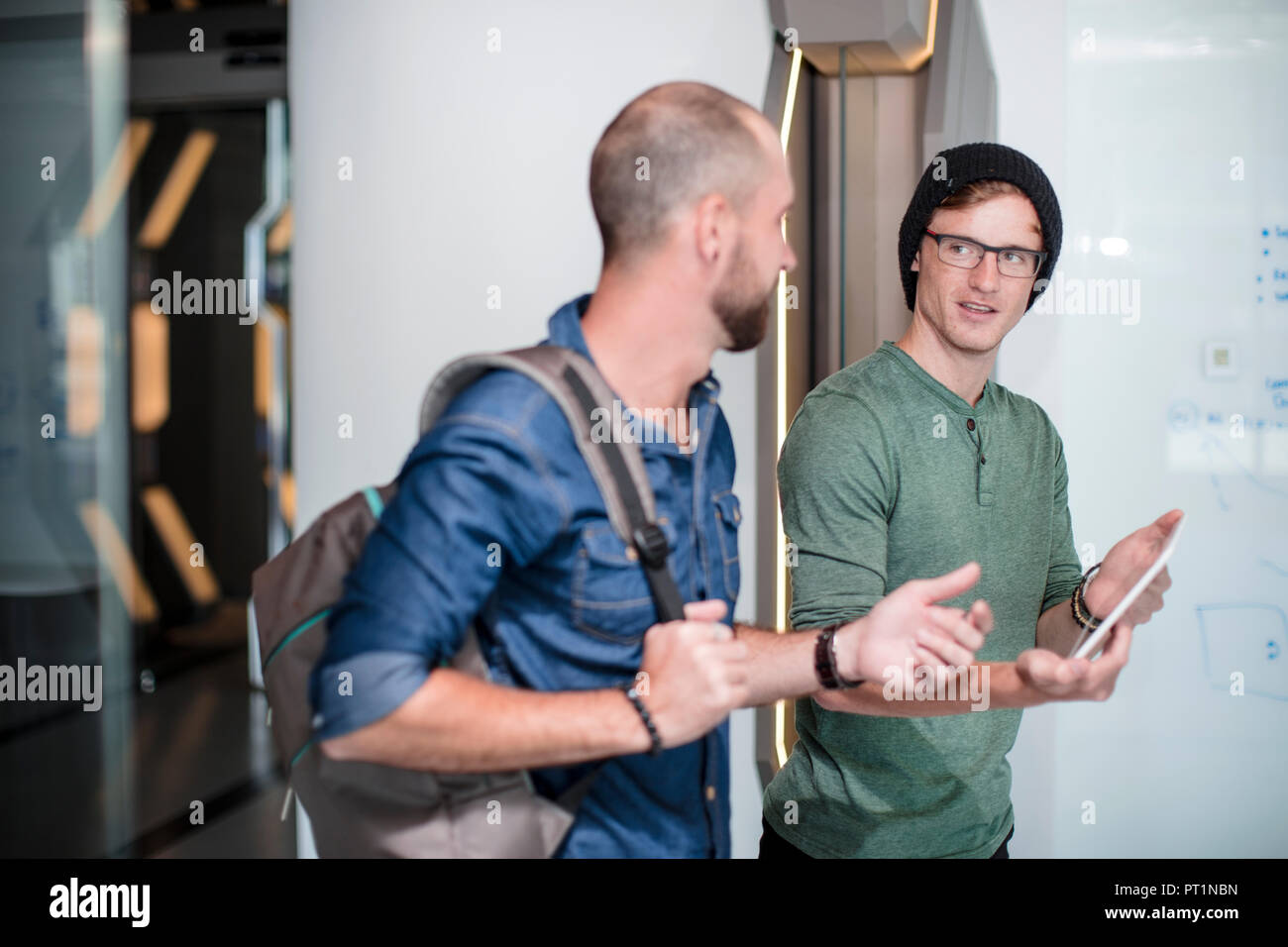 Colleagues in office discussing work issues Stock Photo