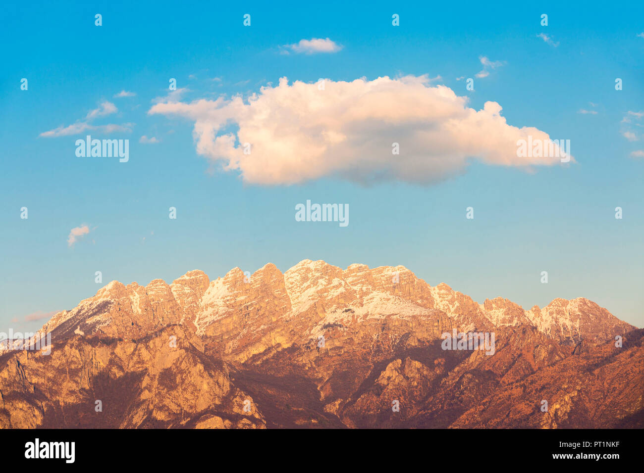 White cloud above Resegone mount at sunset, Lecco, Lecco province, Lombardy, Italy Stock Photo