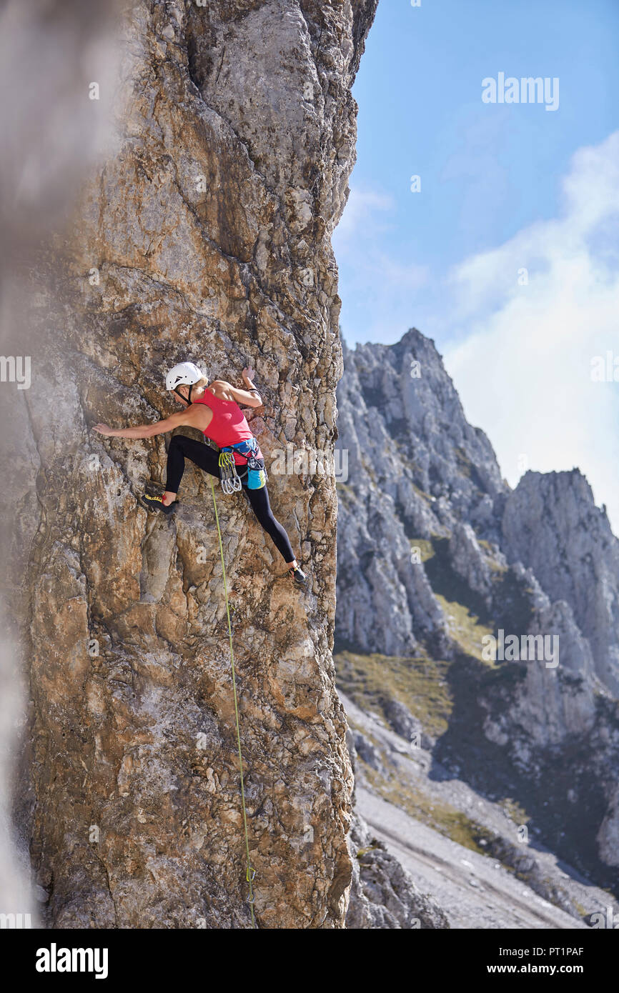 Austria, Innsbruck, Nordkette, woman climbing in rock wall Stock Photo