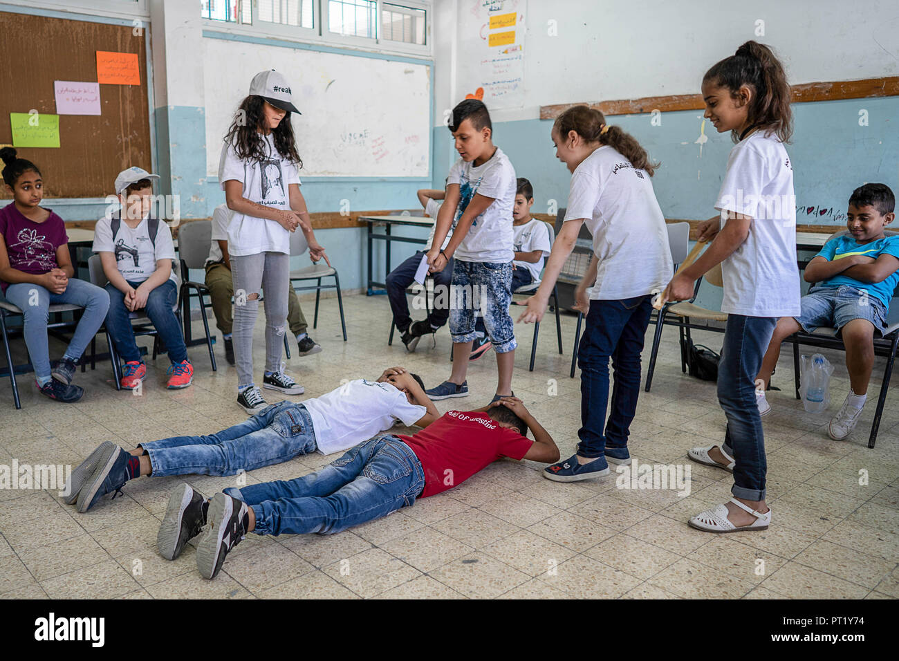 Bethlehem, Palestine. 13th Feb, 2018. Students are seen In a drama class re-acting a situation where Palestinian youths were arrested by the Israeli forces during the summer camp.The Return Summer Camp was organised for children of the Aida refugee camp, it was established in 1950 by the Palestinians who were expelled from their homes from 27 towns throughout Palestine, namely Nasra, Tabaria, Jerusalem, Acre, Jaffa, Haifa and Hebron. This is a 4th generation of refugees, 130 children ranging from 4 to 16 years of age being overlooked by 20 instructors and volunteers and it was funded by Stock Photo